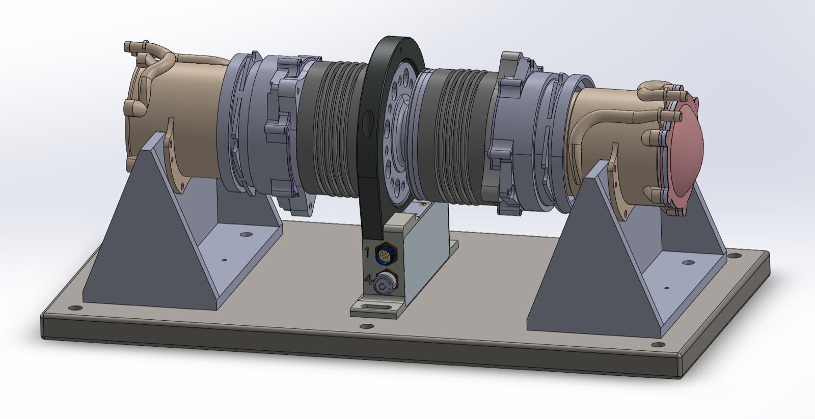 SolidWorks render of the dynamometer: two in-hub motor assemblies mounted back-to-back on triangular pedestal brackets bolted to a baseplate, joined by two couplings with an in-line torque transducer between them.